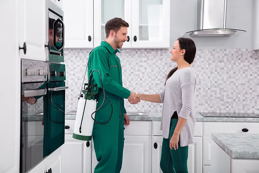 Male Pest Control Worker Shaking Hands With Happy Client - Champaign, IL